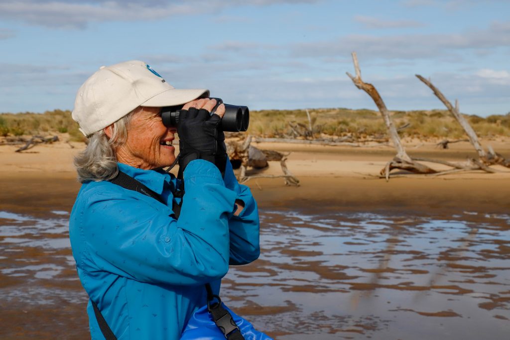 Woman looks through binoculars